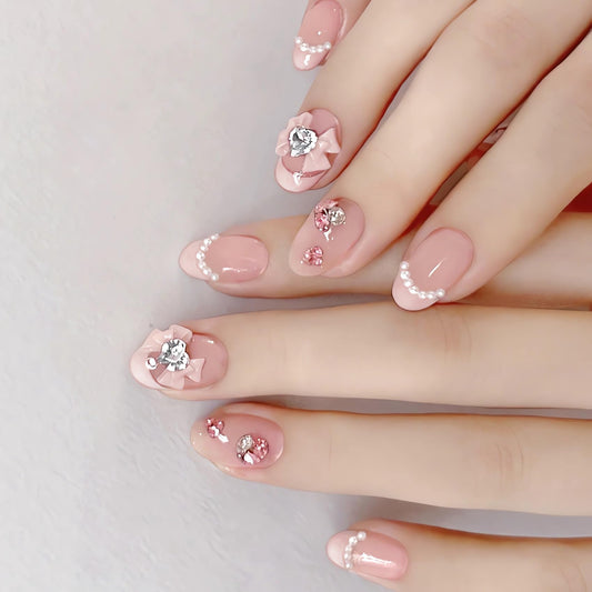 IMSOHOT Oval Press on Nails Pink Short Fake Nails French Tips Acrylic False Nails with Bow Tie Charms Designs Rhinestone Pearl Full Cover Glue on Nails for Women and Girls 24Pcs