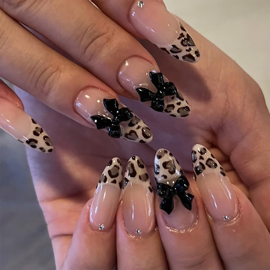 24Pcs Bow Press on Nails Medium Almond Fake Nails Black with Leopard Print Design Bow Charms False Nails Glossy Full Cover Artificial Glue on Nails Nude Stick on Nails Valentine's Day Nails for Women