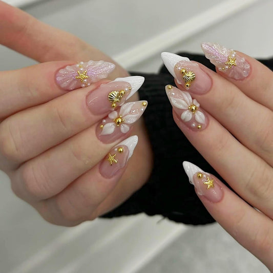 Almond Press on Nails Long Fake Nails Nude Acrylic Nail Press ons SEENEEY French White Floral and Gold Charm Designs Cute Stick on Nail for Women 24pcs