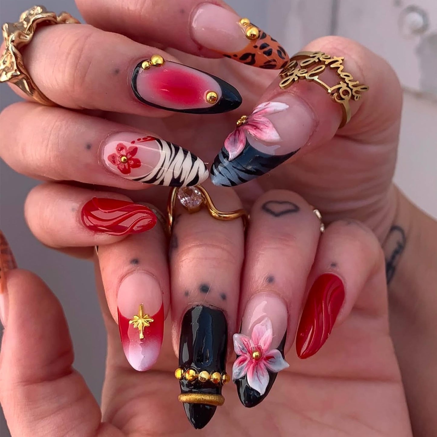 SEENEEY Almond Press on Nails Long Fake Nails Red Artificial Nail Black French Pink Floral and Gold Charm Designs Cute Stick on Nail for Women 24pcs