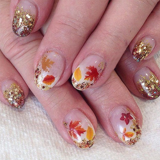 24Pcs Fall Maple Leaf Press on Nails Short Oval Almond Fake Nails with Gold Glitter Designs Thanksgiving Maple Leaves False Nails Full Cover Glossy Nude Acrylic Glue on Nail for Women Autumn Nails DIY