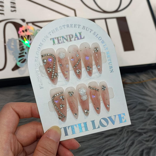 TENPAL Extra Long Stiletto Fake Nails with Coral Shimmer Base,3D Floral Chains Camellia Press on Nails Long Drop Shape,10pcs Versatile Soft Gel False Nails with Tools,Crystal Glitter Nails(XS,Orange)